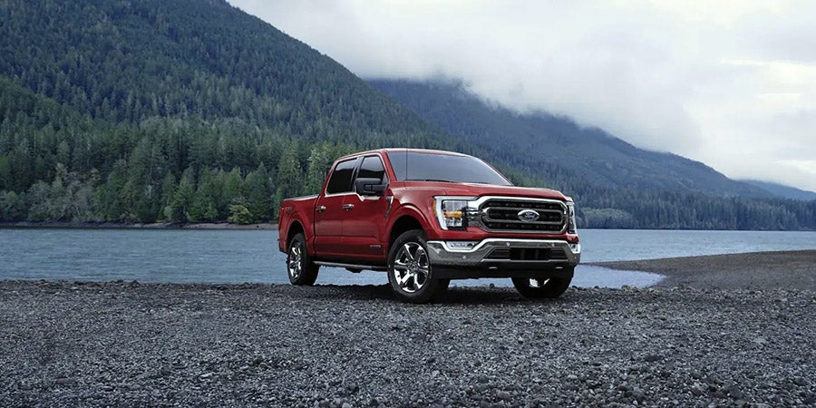 Red Ford F-150 parked near a lake